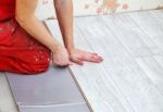 Handyman Laying Down Laminate Flooring Boards Stock Photo