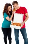 Young Couple Sharing Pizza Stock Photo