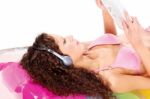 Girl On Air Mattress Reading Newspaper Stock Photo