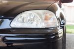 Closeup Headlight Of Black Coupe Stock Photo