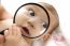 Baby Holding Magnified Glass