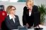 Businesswomen Enjoying At Work Desk