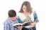 Mother And Son Reading A Bible Over A Black Background