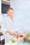 Woman Making Fruit Salad In Kitchen