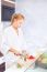 Woman Making Fruit Salad In Kitchen