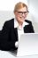 Smiling Young Female Executive At Work Desk