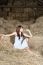 Woman In White Dress On Haystack