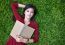 Woman Lying On Grass With  Book