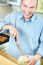 Man And Melon In Kitchen