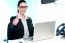 Young Businesswoman Sitting On Desk  Gesturing Thumbs Up