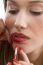 Woman Applying Red Lipstick