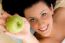 Smiling Woman Offering Apple On An Isolated Background