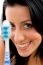 Front View Of Smiling Woman With Toothbrush On White Background