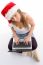 Sitting Female Wearing Christmas Hat And Holding Laptop