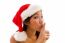 Woman With Christmas Hat And Gesturing To Keep Silent