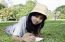 Young Woman Lies On Green Summer Meadow With Book