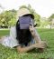 Woman Laying On Grass And Thinking In Park