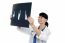 Cheerful Female Doctor Reviewing Patients X-ray Report