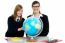 Teacher And Student Viewing Globe In Geography Classroom