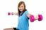 Cute Young Girl Stretching Dumbbells Sideways