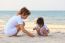 Asian Family Play Sand On Beach