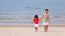 Asian Boys Holding Hands On Beach