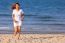 Asian Woman Running On Beach