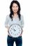 Cheerful Brunette In Casual Presenting A Wall Clock