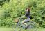 Happy Smiling Girl Riding A Bicycle In The Park