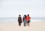 Beautiful Family Walking On Beach