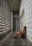 Asian Girl Sitting On Corridor Floor