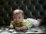 Baby Lying On Sofa Bed With Eyes Contact To Camera