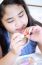 Little Girl With A Pastel Color And Red Nail Polish