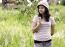 Woman Outdoors Holding Flower Smiling