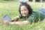 Girl Playing Computer Tablet On Green Field