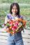 Young Woman Holding Bouquet Of Flower