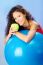 Women Behind Blue Pilates Ball Holding Green Apple