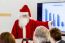 Female Santa Claus Presenting In Business Meeting