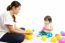 Baby Girl Is Playing Ball With Her Mother On White Background