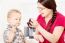 Mother Feeding Child With Grape