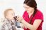 Mother Feeding Child With Grape