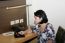 Business Woman Sitting In Her Office Using A Tablet Computer