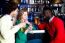 Group Of Three Friends In A Bar Drinking Beer