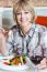 Woman Relishing Her Meal With Red Wine