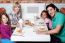 Cheerful Family Of Four Enjoying Dinner