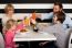 Family Toasting Smoothies In Restaurant