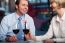 Happy Couple Drinking Red Wine At A Restaurant