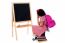 Thoughtful Kid Sitting In Front Of Blackboard