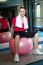 Pretty Fit Woman Sitting On Pink Swiss Ball