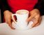 Hands Of Waiter Serving A Cup Of Cappucino